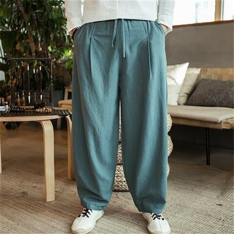Person wearing teal pants in a living room setting