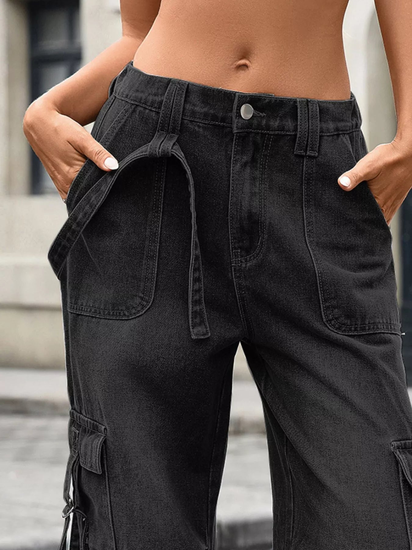 Person wearing black cargo pants with a blurred background
