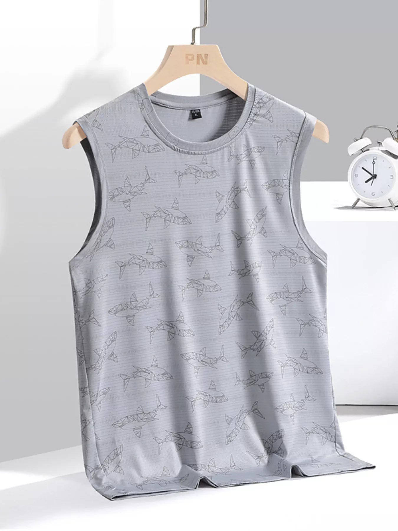 Gray sleeveless shirt with dog pattern on a hanger against a white background