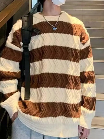 Person wearing a brown and white striped sweater with a black strap over shoulder.
