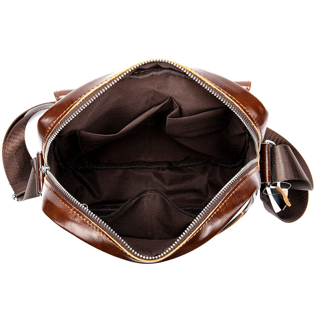Brown leather bag with open front compartment on a white background