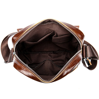 Brown leather bag with open front compartment on a white background