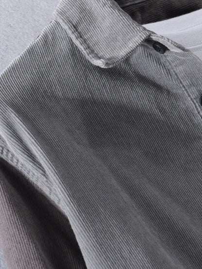 Close-up of gray corduroy shirt with a focus on texture and stitching.