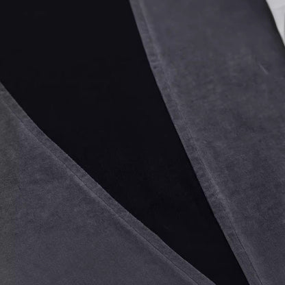 Close-up of dark gray fabric with a subtle pattern on a black background