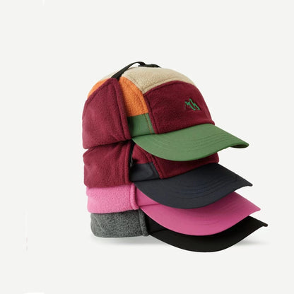 Stack of colorful caps on a white background
