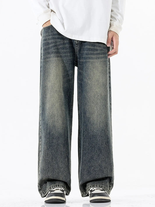 Person wearing wide-leg jeans and a white shirt on a white background