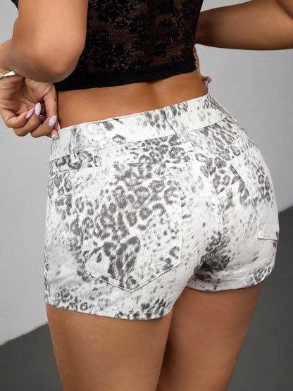 Person wearing white shorts with black leopard print pattern against a gray background