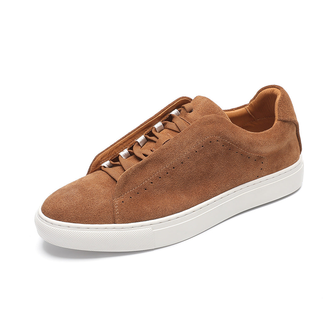 Brown suede sneaker with white sole on a white background