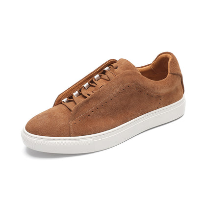 Brown suede sneaker with white sole on a white background