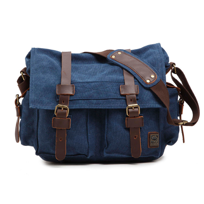 Blue canvas bag with brown leather straps on a white background