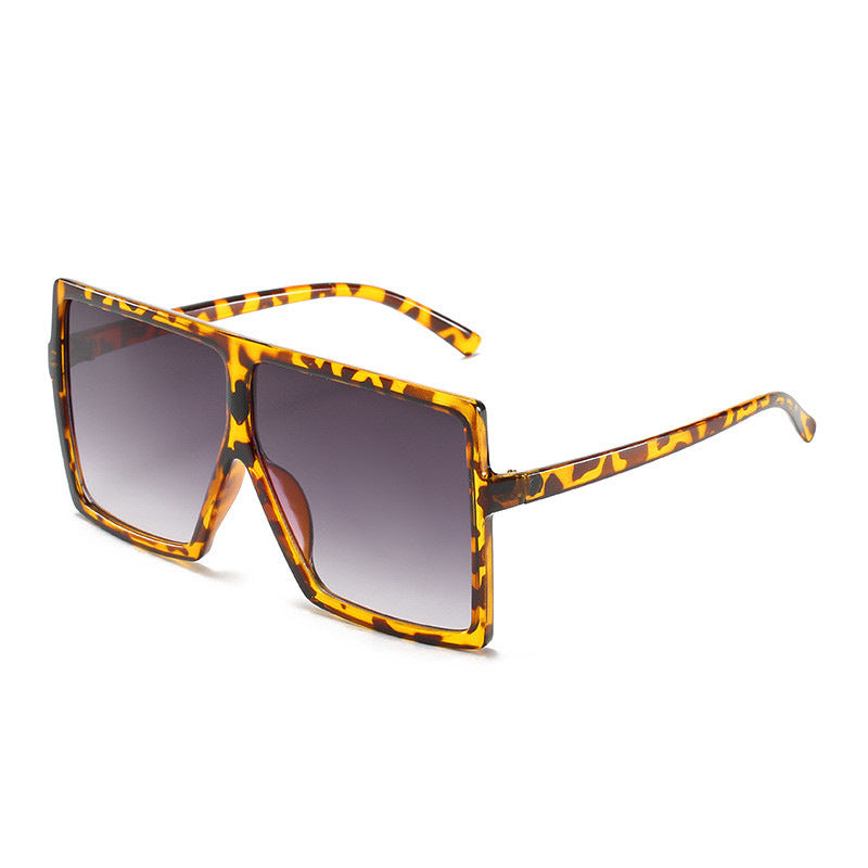 Sunglasses with tortoiseshell frame and gradient lenses on a white background