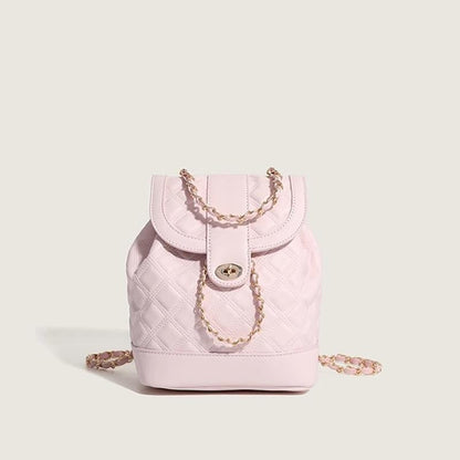 Pink quilted handbag with a chain detail on a light gray background
