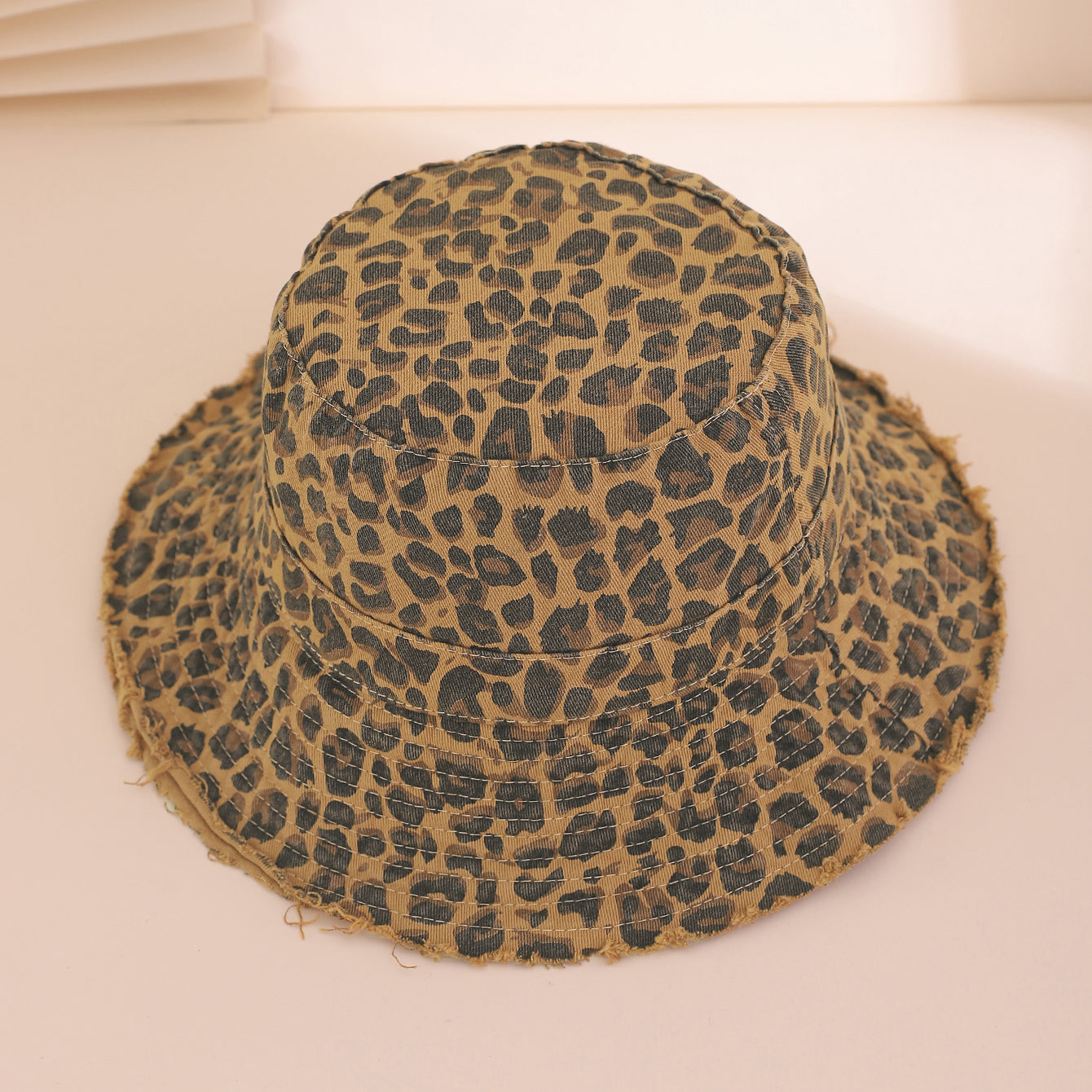 Leopard print bucket hat on a beige background