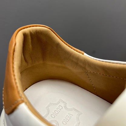 Close-up of a brown leather shoe lining with a white sole and visible brand logo.
