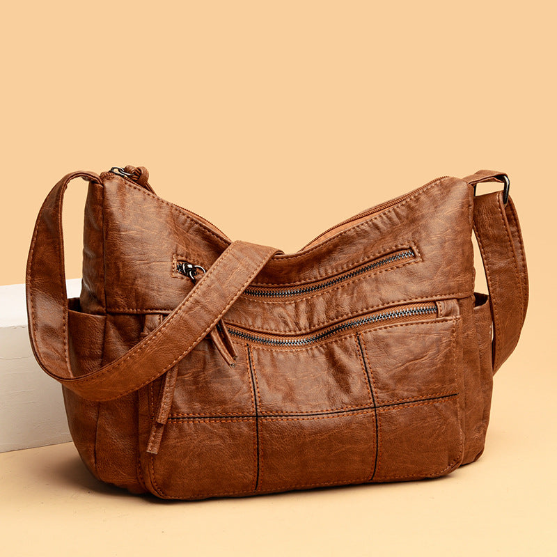 Brown leather handbag on a beige background