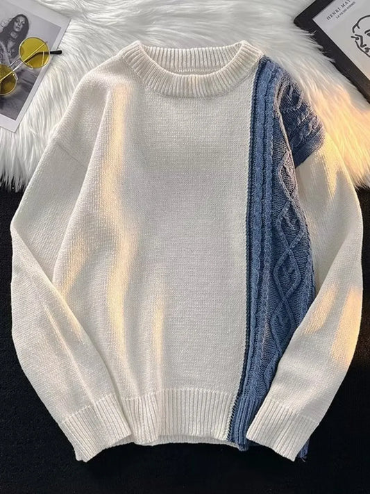 White sweater with blue patterned sleeve on a white background