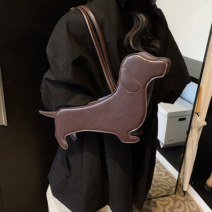 Person wearing a black coat with a brown dachshund-shaped backpack.