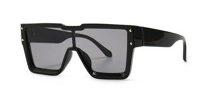Black sunglasses with a large frame on a white background