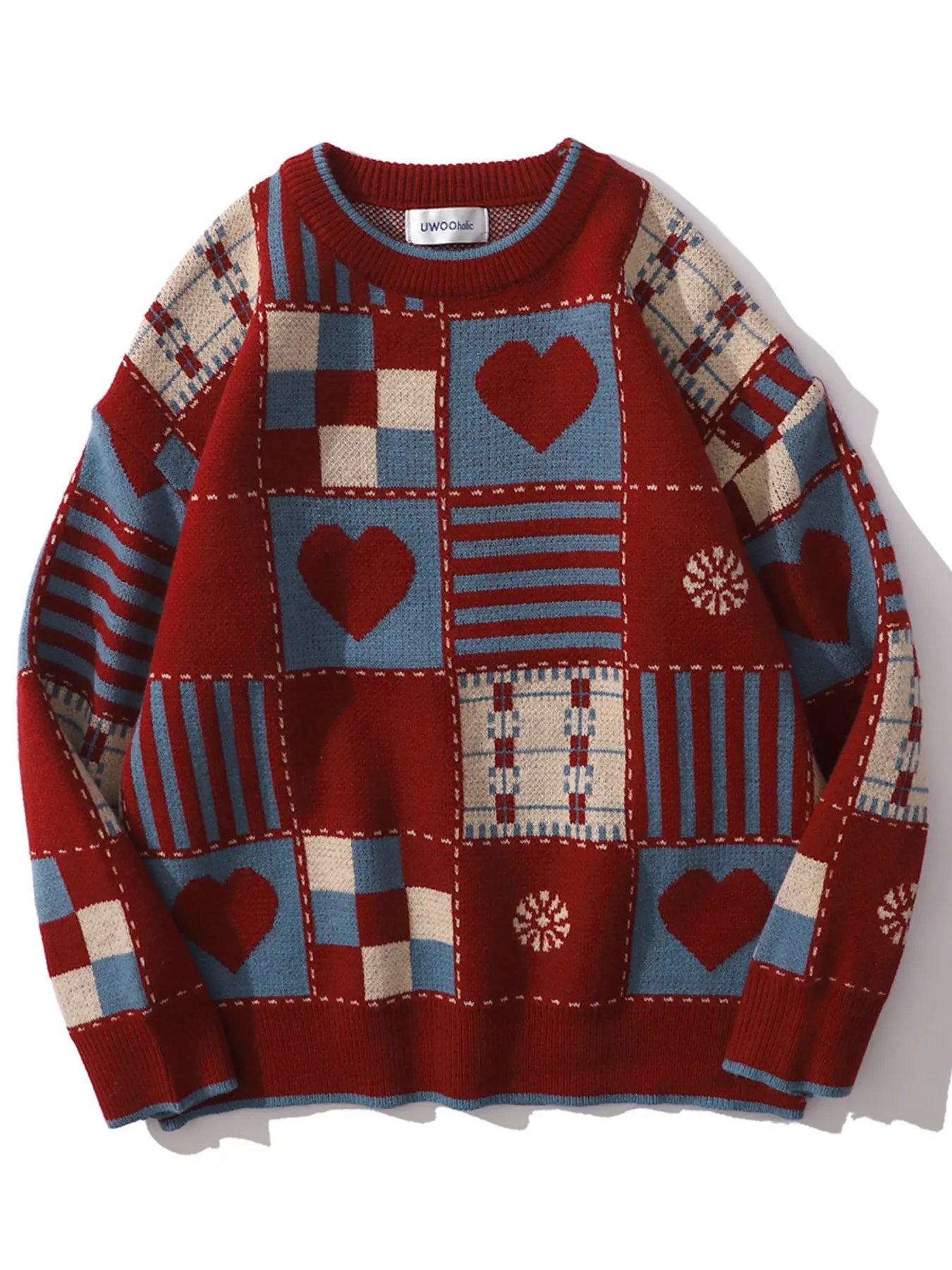 Colorful patchwork sweater with heart and geometric patterns on a white background