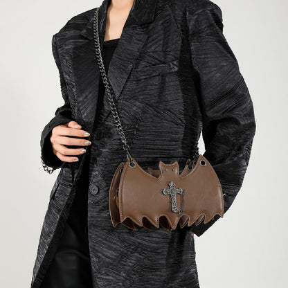 Handbag shaped as a bat being worn on a white background.