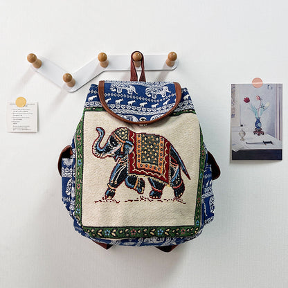 Backpack with elephant design hanging on a wall hook