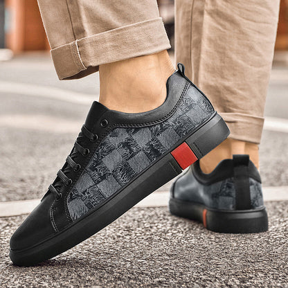 Black patterned sneakers with a red accent on a neutral background