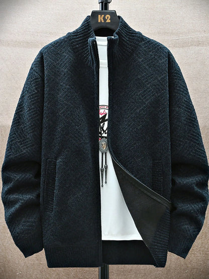 Dark green knitted cardigan on a hanger with a brand logo against a neutral background