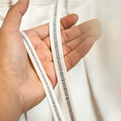 Hand holding a drawstring with a blurred background
