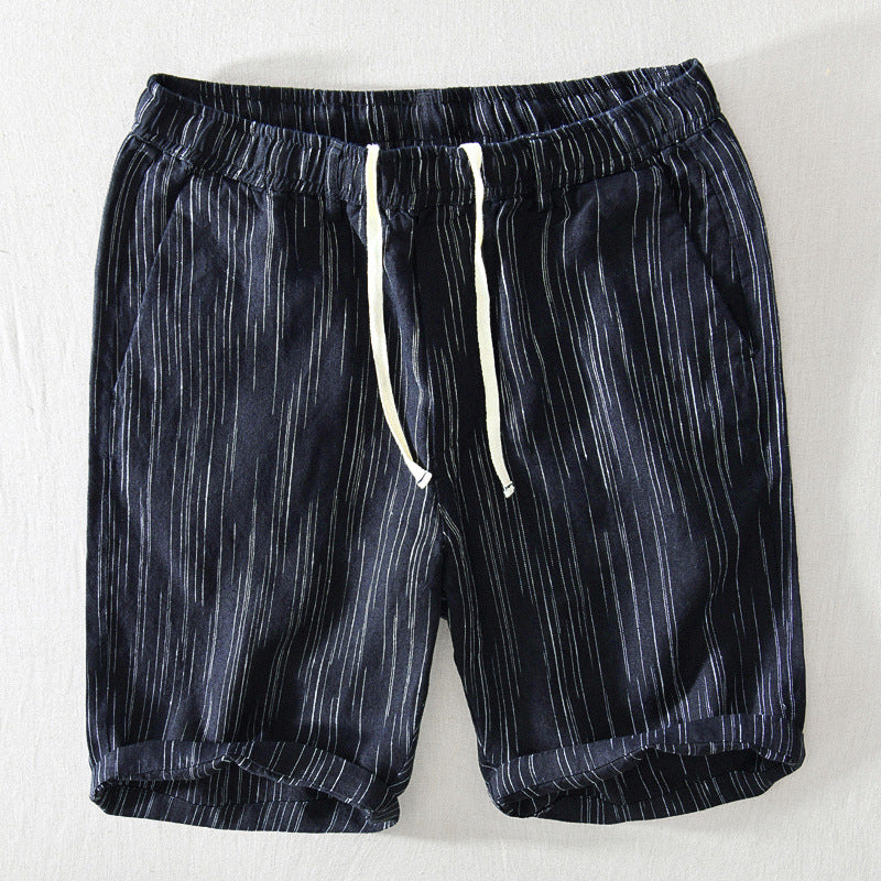 Navy shorts with white stripes on a light gray background