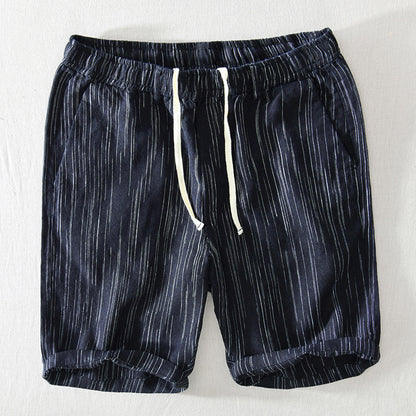 Navy shorts with white stripes on a light gray background
