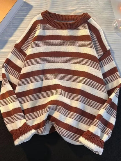 Striped sweater with brown and white colors on a flat surface
