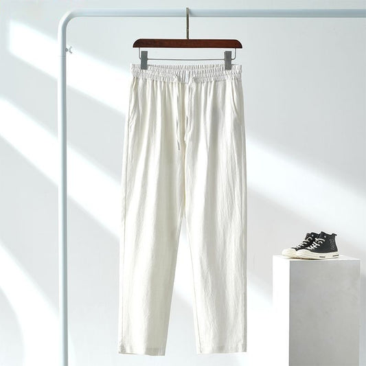 White pants on a hanger with a white background