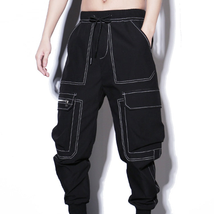 Black cargo pants with white stitching on a plain background