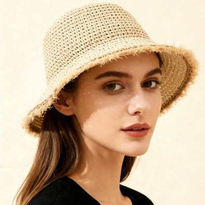 Woman wearing a straw hat with a soft focus background