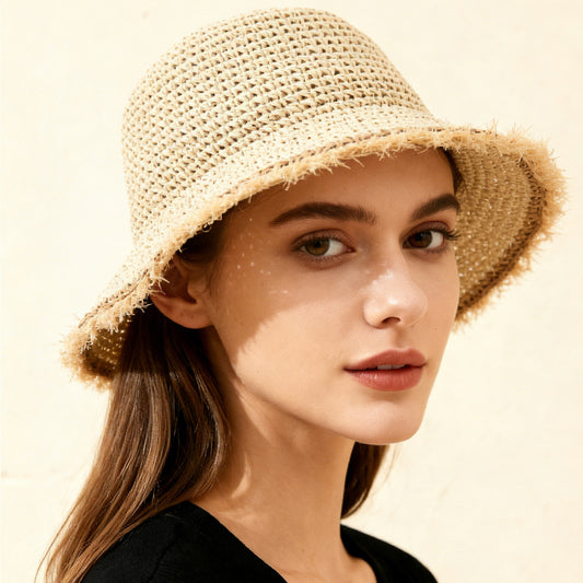 Woman wearing a straw hat with a soft focus background