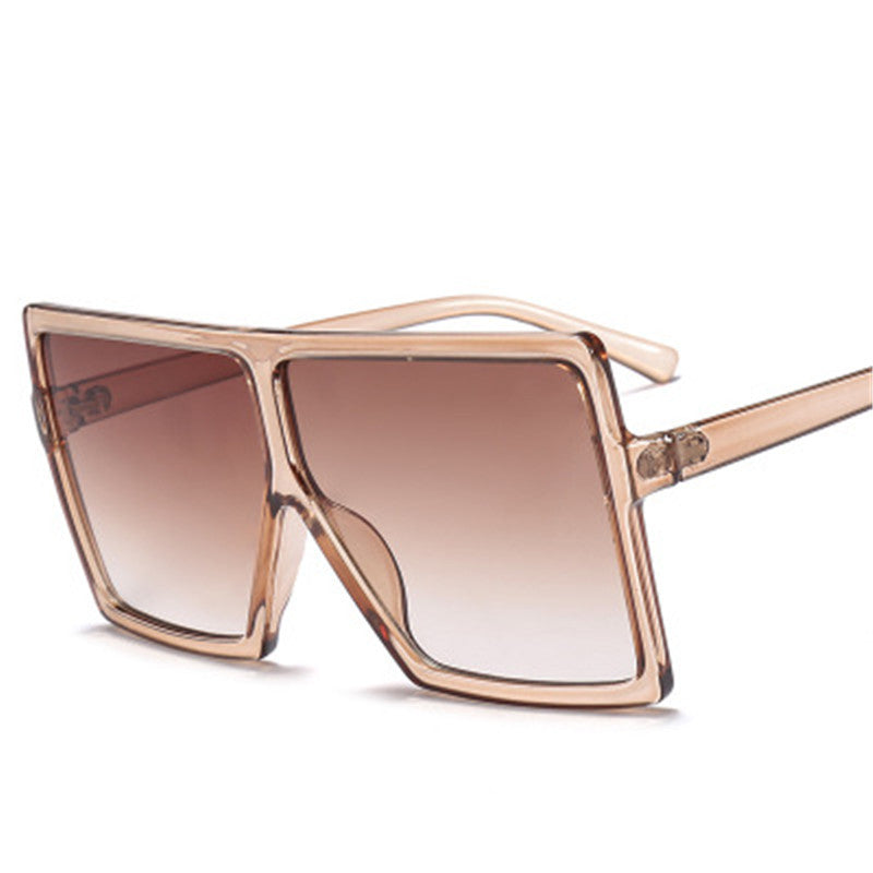 Sunglasses with a rose gold frame and gradient lenses on a white background