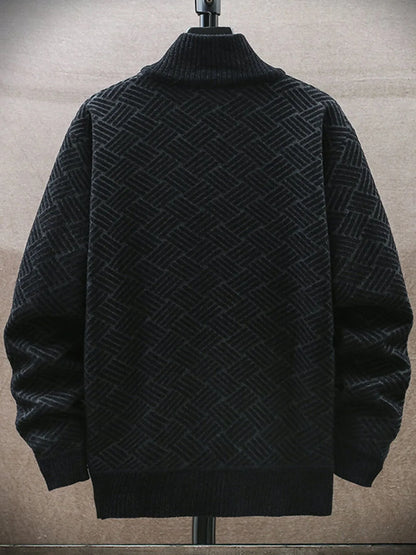 Black textured sweater on a mannequin against a neutral background