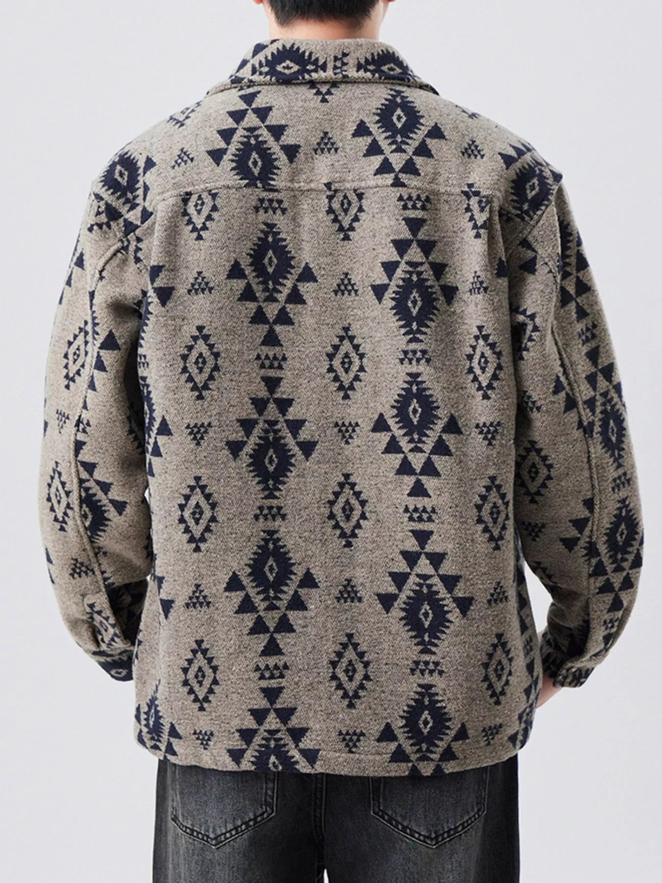 Person wearing a patterned jacket with a white background