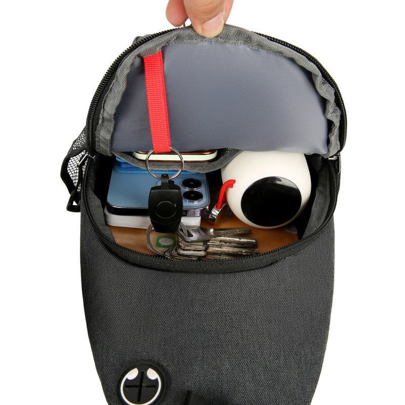 Black pouch with various items like a phone, keys, and a mug inside on a white background