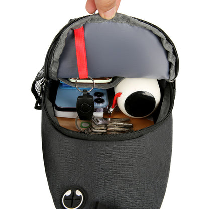 Black pouch with various items like a phone, keys, and a mug inside on a white background