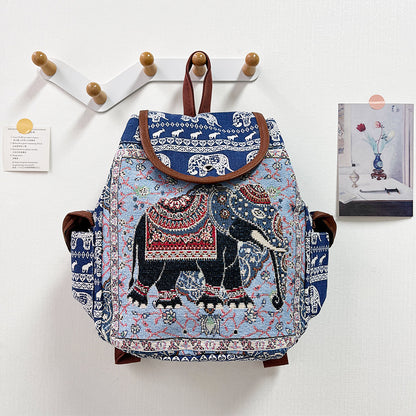 Backpack with elephant design hanging on a wall hook