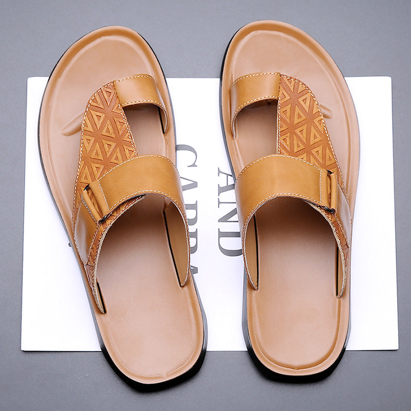 Pair of tan sandals on a gray background