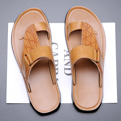 Pair of tan sandals on a gray background