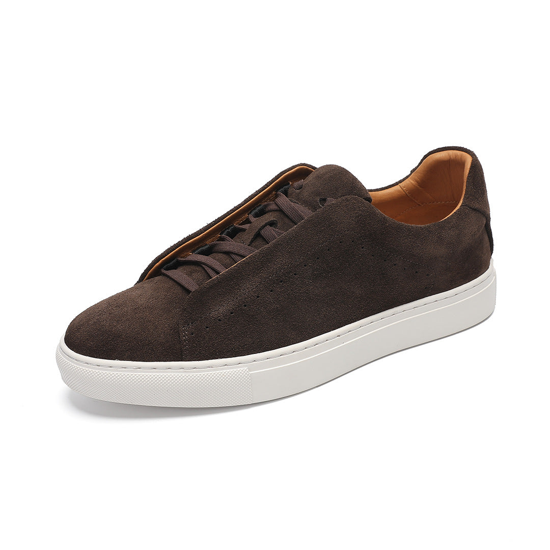 Brown suede sneaker with white sole on a white background