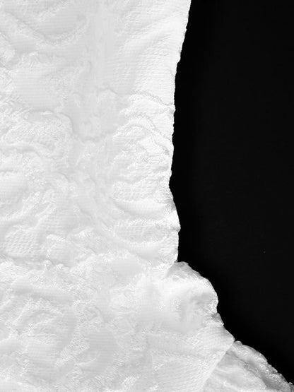 Close-up of textured white fabric with a black background