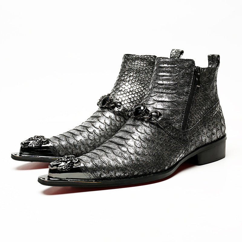 Pair of silver metallic boots with decorative elements on a white background