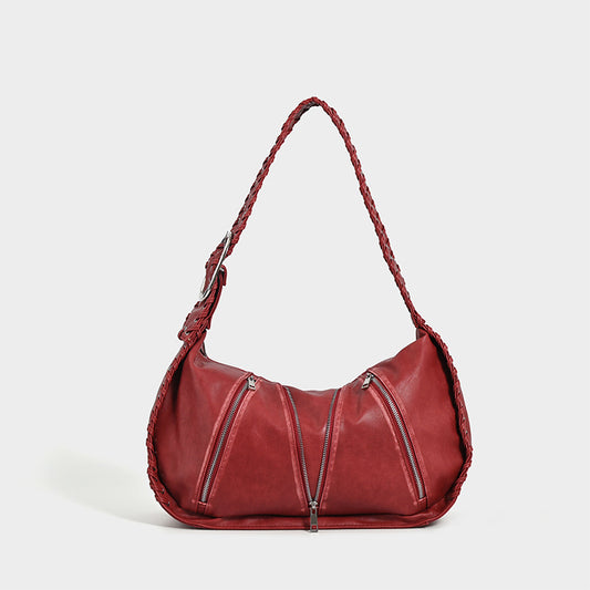 Shoulder bag with zipper details on a white background.