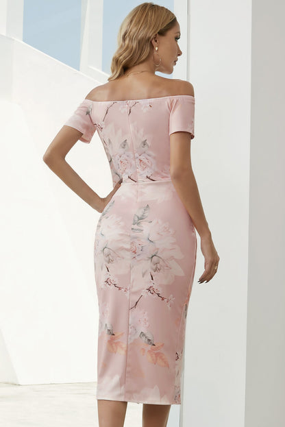 Woman wearing a pink floral off-shoulder dress against a white background