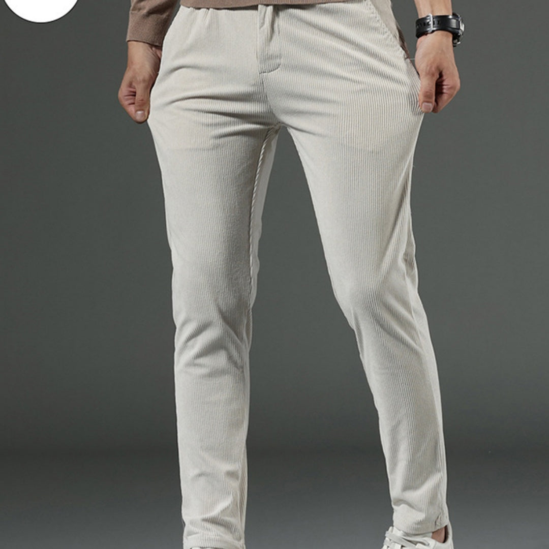 Light gray pants worn by a person on a dark gray background