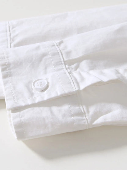 White shirt with rolled-up sleeve on a light background